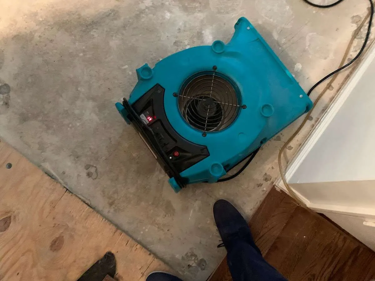 Air mover drying subfloor during Commercial Water Damage Restoration in Ulysses